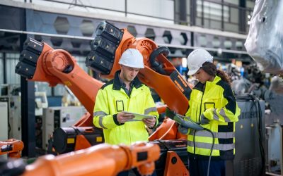 Two,Workers,Wearing,Hard,Hats,And,High-visibility,Jackets,Review,Plans